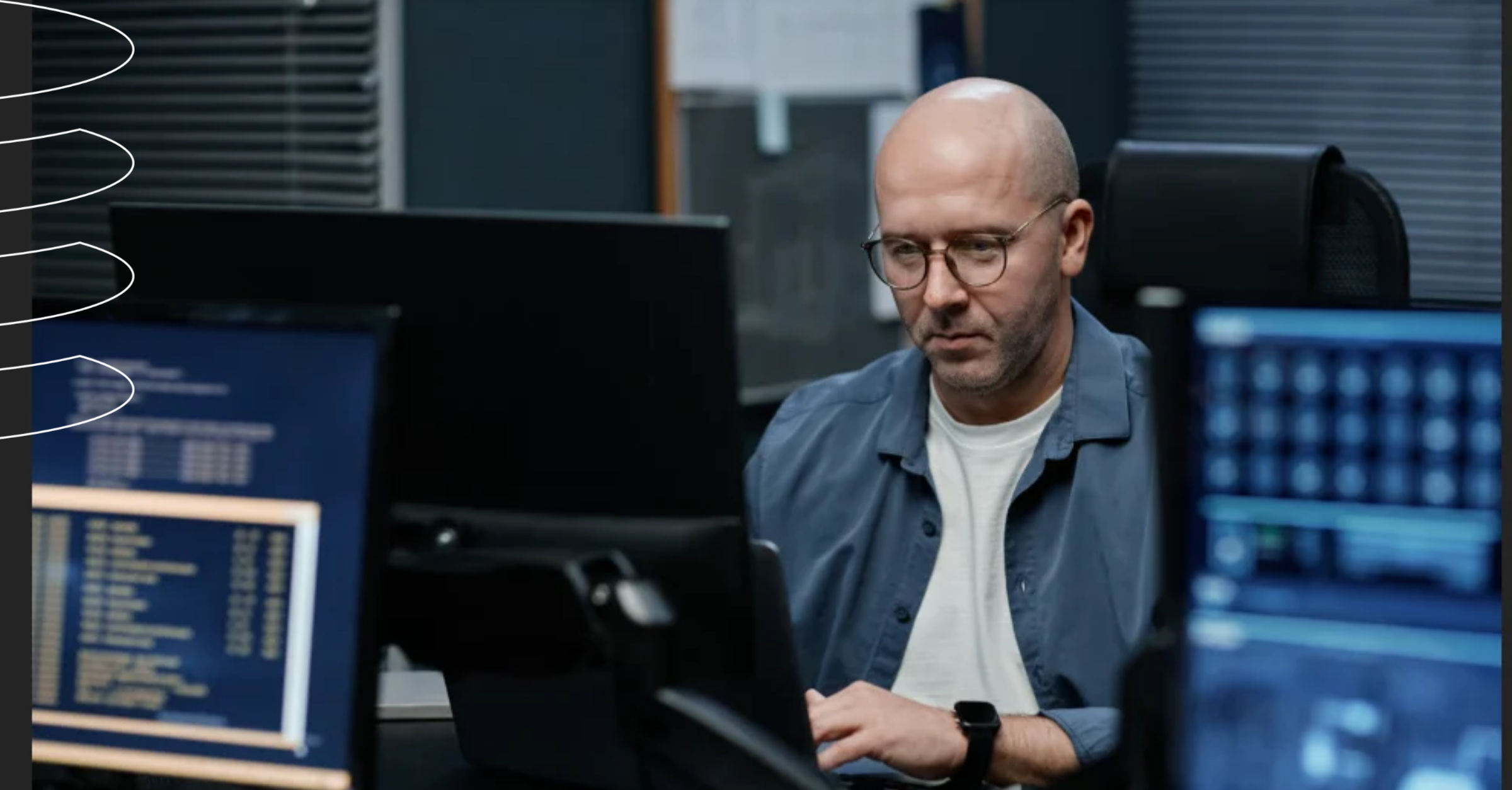 Database administrator investigating an ERP slowdown at monitors in a dark office